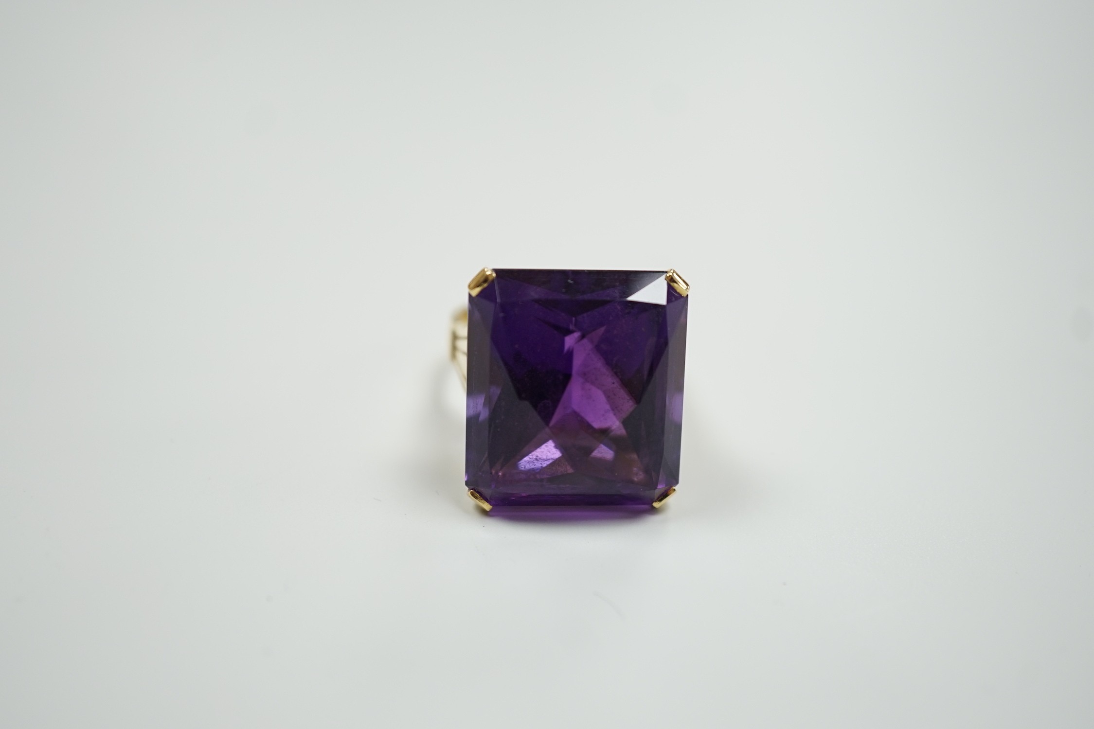 A large modern 18ct gold and fancy rectangular cut single stone amethyst set dress ring, size W, gross weight 22 grams